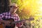 Young man Asia playing acoustic guitar.