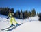 Young man backpacker skiing up and down slopes. Male skier training in sunny winter day. Backcountry skiing concept.