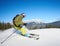 Young man backpacker skiing up and down slopes. Male skier training in sunny winter day. Backcountry skiing concept.