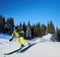 Young man backpacker skiing up and down slopes. Male skier training in sunny winter day. Backcountry skiing concept.