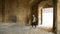 Young man with bag entering ancient castle in Naples, Castel dell\'Ovo tour