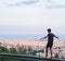 Young man balancing in front of Barcelona skyline