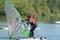 Young man balancing on windsurfing board