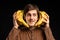 Young man with banana on black