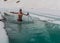 Young man bathing in the ice hole