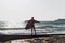 Young man in a bathrobe on the beach