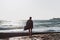 Young man in a bathrobe on the beach