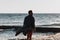 Young man in a bathrobe on the beach