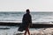 Young man in a bathrobe on the beach