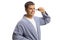 Young man in a bathrobe using an ear trimmer