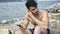 Young man at beach listening to music with earphones