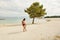 Young man on the beach, young muscular man exercising on the beach, young muscular man doing bodibuilding exercises on the beach,