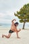 Young man on the beach, young muscular man exercising on the beach, young muscular man doing bodibuilding exercises on the beach,