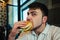 A young man with a beard enjoys fast food