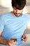 Young man with beard sitting and looking at mobile phone