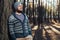 A young man with a beard walks in a pine forest. Portrait of a brutal bearded man Autumn forest