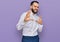 Young man with beard wearing business shirt disgusted expression, displeased and fearful doing disgust face because aversion