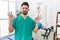 Young man with beard working at pain recovery clinic relax and smiling with eyes closed doing meditation gesture with fingers