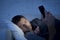 Young man in bed couch at home falling asleep late at night while using mobile phone in low light