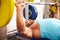 Young man bench pressing weights at a gym, side view close-up