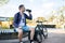 Young man on a bicycle drink water. Active healthy lifestyle. Sports man resting after exercise in nature.