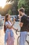 young man with bicycle eating ice cream while his girlfriend