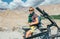 Young man bike traveler rest on high mountain road in Himalaya