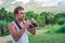 Young man with binoculars in hand watching the wild nature in the tropics