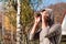 Young man with binoculars watching the nature