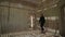 Young man in black in abandoned building walking in room. Ghost town Kolmanskop.