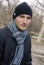 Young man in black cap and striped scarf