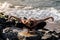 Young man in black pants doing yoga on rock beach in India  morning time