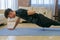 Young man with black sportswear practicing exercise in the living room at home