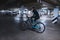 Young man on a blue bike rides through an underground parking lot. Cyclist can ride in an underground parking lot