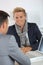 Young man with blue jacket meeting banker