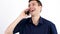 Young man in blue shirt talking on the phone over gray background