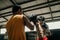 young man boxer doing exercise hitting punching competing with his trainer