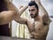 Young Man Brushing and Combing Hair in Mirror