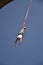 Young man bungee jumper hanging on a cord