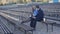 Young man and business lady are sitting on a bench in the park