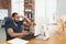 Young man, businessman working in office, looking on computer screen, monitor, with blank white sheet, whiteboard near