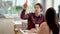 Young man calling a waiter while dating in restaurant