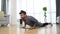 Young man cancer survivor practicing home workout yoga training, stretching muscles and breathing exercise for healthy life after