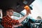 Young man carefully cleaning the interior of his car