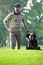 Young man carrying trolley with golf bag