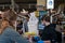 Young man cashier working at supermarket wearing face mask and gloves