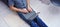 Young man in casual clothes sitting on floor and working on his laptop computer at home. Stay home and work online. Quarantine