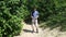 A young man with cerebral palsy travels. Behind the backpack, going through the woods with a backpack and looking at maps.