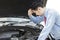 Young man checking the broken machine car