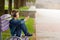 Young man checking his mobile phone outdoors. Teenager in headphones uses his smartphone